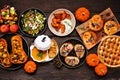 Delicious autumn meal table scene. Top view on a dark wood background. Royalty Free Stock Photo