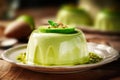 Avocado pudding on white plate with sauce on wooden table