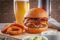 Delicious bacon burger with onion rings Royalty Free Stock Photo