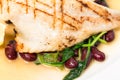 Delicious baked dorado fillet with chard. Royalty Free Stock Photo