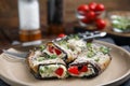 Delicious baked eggplant rolls with cheese, tomato and microgreens on plate, closeup Royalty Free Stock Photo