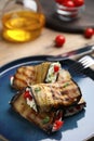 Delicious baked eggplant rolls with cheese, tomatoes and microgreens on plate, closeup Royalty Free Stock Photo