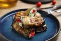 Delicious baked eggplant rolls with cheese, tomatoes and microgreens on plate, closeup Royalty Free Stock Photo