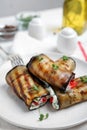 Delicious baked eggplant rolls served on table, closeup Royalty Free Stock Photo