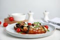 Delicious baked eggplant rolls served on white wooden table Royalty Free Stock Photo