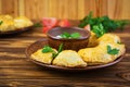 Delicious baked empanadas on wooden background