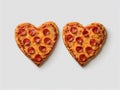 Delicious baked pizzas in the shape of a heart, with various vegetables and sausage, on a white background