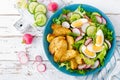 Delicious baked potato, boiled egg and fresh vegetable salad of lettuce, cucumber and radish. Summer menu for detox diet