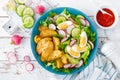 Delicious baked potato, boiled egg and fresh vegetable salad of lettuce, cucumber and radish. Summer menu for detox diet