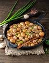 Delicious baked potatoes in cast-iron pan with champignons and green onion. Dish for dinner Royalty Free Stock Photo