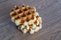 A delicious baked round Belgian waffle with one bite taken