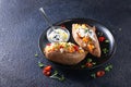 Baked sweet potato or yam, stuffed with chickpeas, rice, vegetables, red chilli pepper and yogurt sauce dressing. Overhead view, Royalty Free Stock Photo