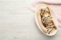 Delicious banana split ice cream with chocolate topping on white wooden table, top view. Space for text Royalty Free Stock Photo