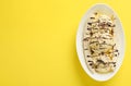 Delicious banana split ice cream with toppings on yellow background, top view. Space for text Royalty Free Stock Photo