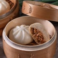 Delicious baozi, Chinese steamed meat bun is ready to eat on serving plate and steamer