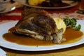 delicious bavarian dish of a knuckle of pork with a potato dumpling in brown beer sauce
