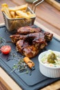 BBQ chicken wings served with Coleslaw salad and french fries Royalty Free Stock Photo