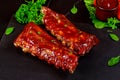 Delicious BBQ pork ribs with herbs and tangy BBQ sauce Royalty Free Stock Photo