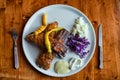 Delicious BBQ ribs with salad and paper on white plate Royalty Free Stock Photo