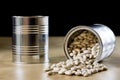 Delicious beans in a metal jar on a wooden kitchen table.