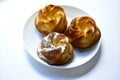 Delicious and beautiful curd rolls on a white plate with sprinkles