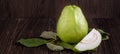 Delicious beautiful Guava set with fresh leaves isolated on wooden table background, close up