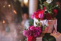 Delicious beautiful wedding cake with white cream decorated with pink and red roses and eucalyptus Royalty Free Stock Photo