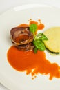 Delicious beef tongue with green, potato gratin and sause on a white plate and white background Royalty Free Stock Photo