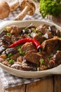 Delicious beef with wild mushrooms, chili pepper and gravy close Royalty Free Stock Photo