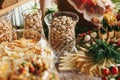 Delicious beer appetizers table at wedding reception. Chips, salty nuts, pistachio, cheese snacks on table at wedding or christmas