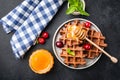 Delicious belgian waffles with honey and sweet cherries