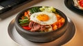 Delicious Bibimbap with Vegetables, Beef, and Egg in a Heated Stone Bowl Royalty Free Stock Photo