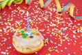 Delicious birthday cake with confetti and streamers on red background Royalty Free Stock Photo