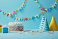 Delicious birthday cake, gifts, party hats and confetti on blue background