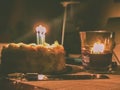 Delicious Birthday cake with lit candles on tabletop. Royalty Free Stock Photo