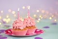 Delicious birthday cupcakes with burning candles on color table Royalty Free Stock Photo