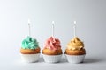 Delicious birthday cupcakes with candles