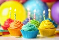 Delicious birthday cupcakes with cream and burning candles on table Royalty Free Stock Photo