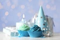 Delicious birthday cupcakes with cream and burning candles on table Royalty Free Stock Photo