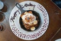 delicious birthday french toast on a skillet with whipped cream and a candle