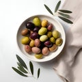 Delicious black, green and red olives with leaves in a bowl, isolated on white background, view from above. AI generated Royalty Free Stock Photo