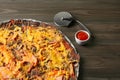 Delicious black pizza served on wooden table. Space for text Royalty Free Stock Photo
