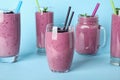 Delicious blackberry smoothie in different on light blue background