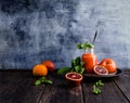 Delicious blood oranges juice in glass on rustic Royalty Free Stock Photo