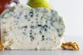Delicious blue cheese dorblu or gorgonzola with pear and walnuts on white background. Close up Royalty Free Stock Photo
