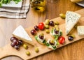 Delicious blue cheese with olives, grapes and salad Royalty Free Stock Photo