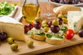 Delicious blue cheese with olives, grapes and salad Royalty Free Stock Photo