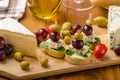 Delicious blue cheese with olives, grapes and salad Royalty Free Stock Photo