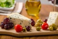 Delicious blue cheese with olives, grapes and salad Royalty Free Stock Photo