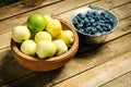 Delicious blueberries and apples in bowls on the table